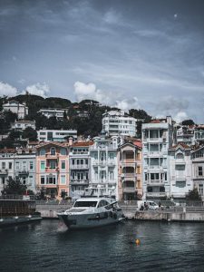 A picturesque scene of colorful buildings and docked yachts along the vibrant waterfront of Arnavutköy, Istanbul.